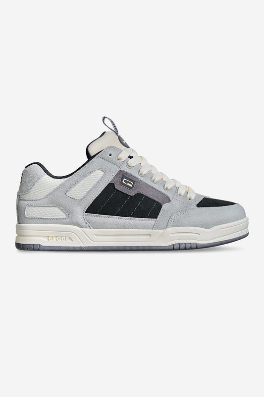 The Tilt Prime - Grey is a gray and black low-top skate shoe with white accents, a textured sole, white laces, and subtle branding on the side and tongue, shown against a plain white background.