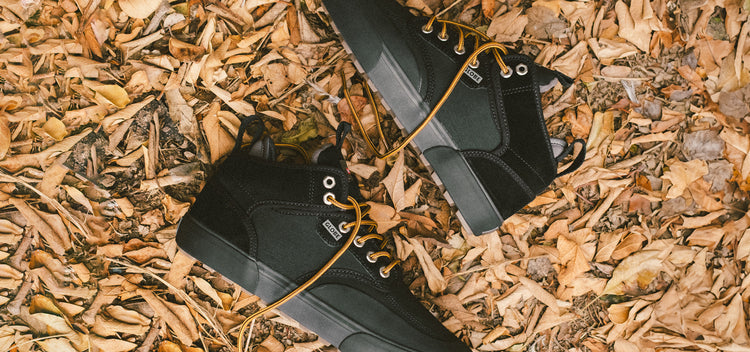 globe motley mid trek shoes on leaf background