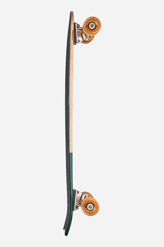The Chromantic Cruiserboard 33" - Beach Bum features a swallow-tail shape, black grip tape, natural wood edges, Resin-7 hard rock maple deck, green underside, and orange wheels, displayed vertically on a white background.