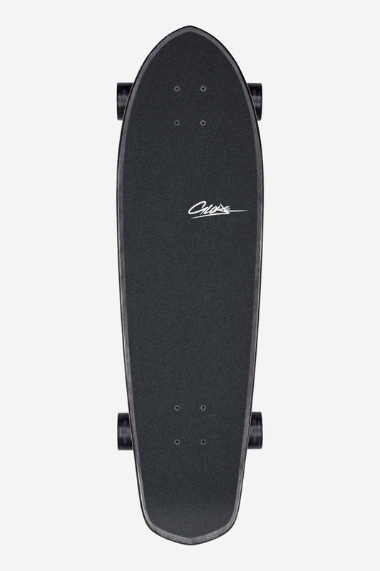 A top-down view of the Big Blazer Cruiserboard 32" - Melt, a black skateboard with a textured deck and four wheels, featuring the word "Chaos" in white script near the center.