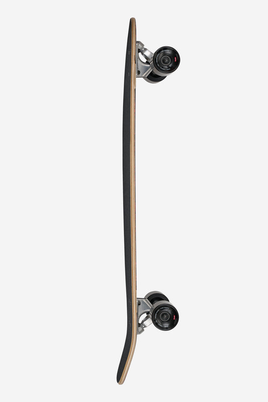 Side profile of The All-Time Longboard 35 showing black grip tape natural wood edge and mounted trucks with wheels