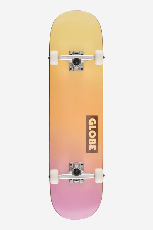 Top-down view of Goodstock Heatwave complete skateboard with gradient yellow to pink deck, white wheels, silver trucks, Globe logo