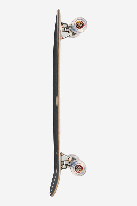 A top-down view of the Forager Cruiserboard 34" - Mesa, placed vertically on a white background, displaying its black grip tape, wooden edges, metal trucks, and clear wheels with red centers.