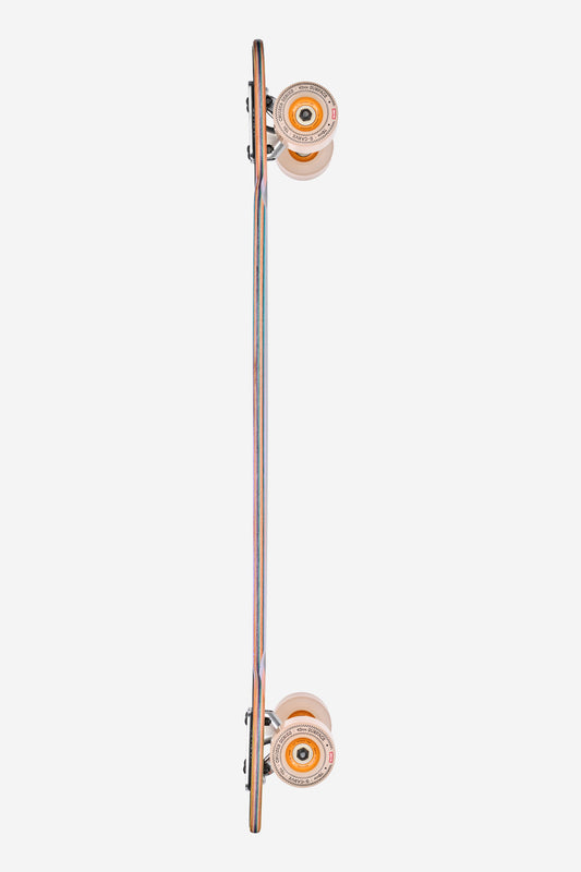 A side view of the Prowler Mid Longboard 34" - Sunstone, featuring orange wheels and a multi-colored layered deck, photographed on a white background.