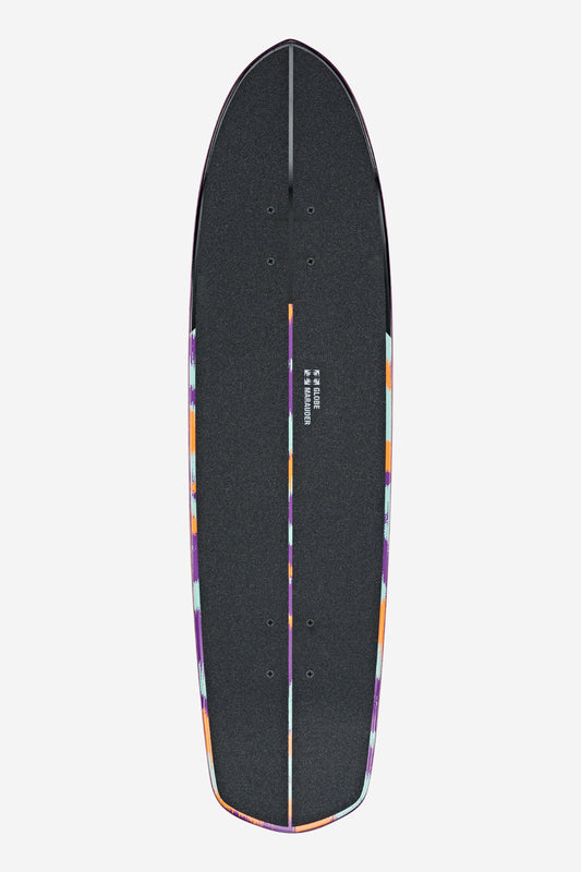 A top view of the Marauder Cruiserboard 32" - Ghost Shark skateboard deck in black, featuring colorful geometric edge patterns and two sets of truck holes, displayed on a white background.