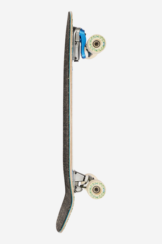 Side view of the Walrus Mami Wata 31 deck with speckled black grip teal edge and cream trucks