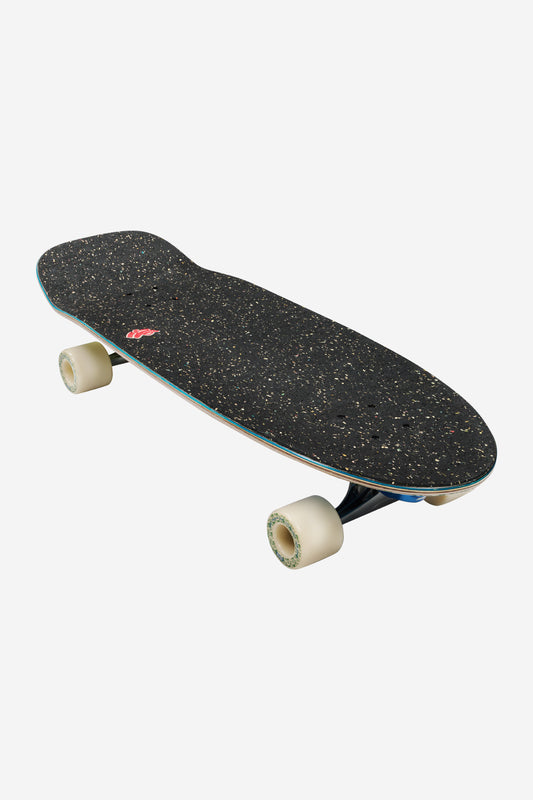 Three quarter view of the Walrus Mami Wata 31 deck showing speckled top teal edge and cream wheels