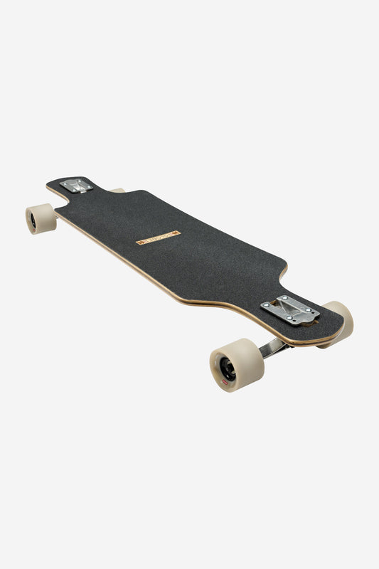 The Geminon 37.5 Longboard 38" - Arid is shown on a plain white background, featuring black grip tape, light-colored wheels, and silver trucks in a drop-through design.
