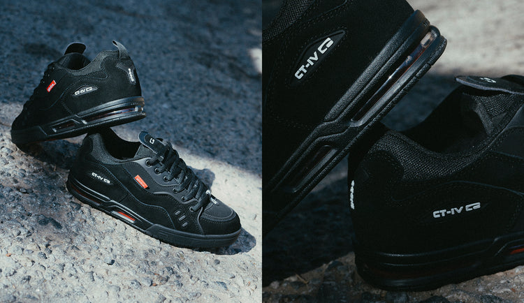 A pair of black athletic sneakers with white and red accents displayed outdoors on a textured concrete surface; close-up shows CT-IV branding on the side of the shoes.