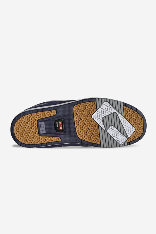 The image shows the sole of the Globe CT-4 - White/Navy skate shoe, featuring brown, gray, black, and white rubber with geometric tread, a red rectangular logo, and signature traction details.