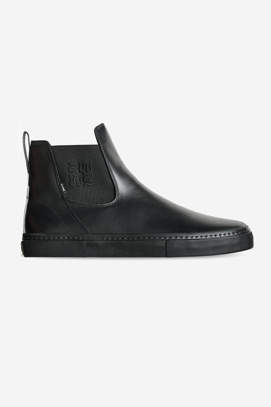 The Dover II - Wasted Talent Black/Snake is a black leather Chelsea boot with snake print accents, featuring elastic side panels, a back pull tab, and a flat rubber sole. Displayed on a plain white background.