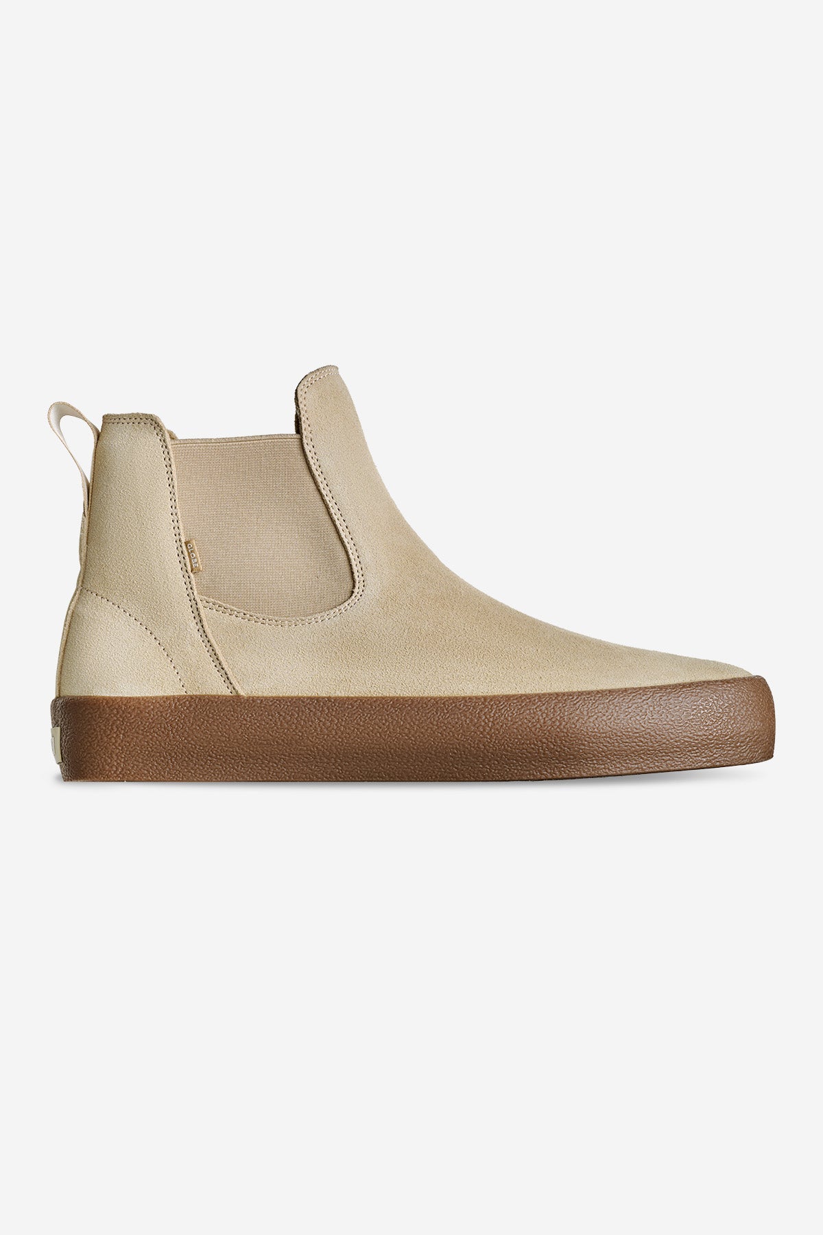 The Dover II - Safari/Crepe is a beige slip-on ankle boot with elastic side panels and a tan rubber sole, shown in left side profile against a white background.