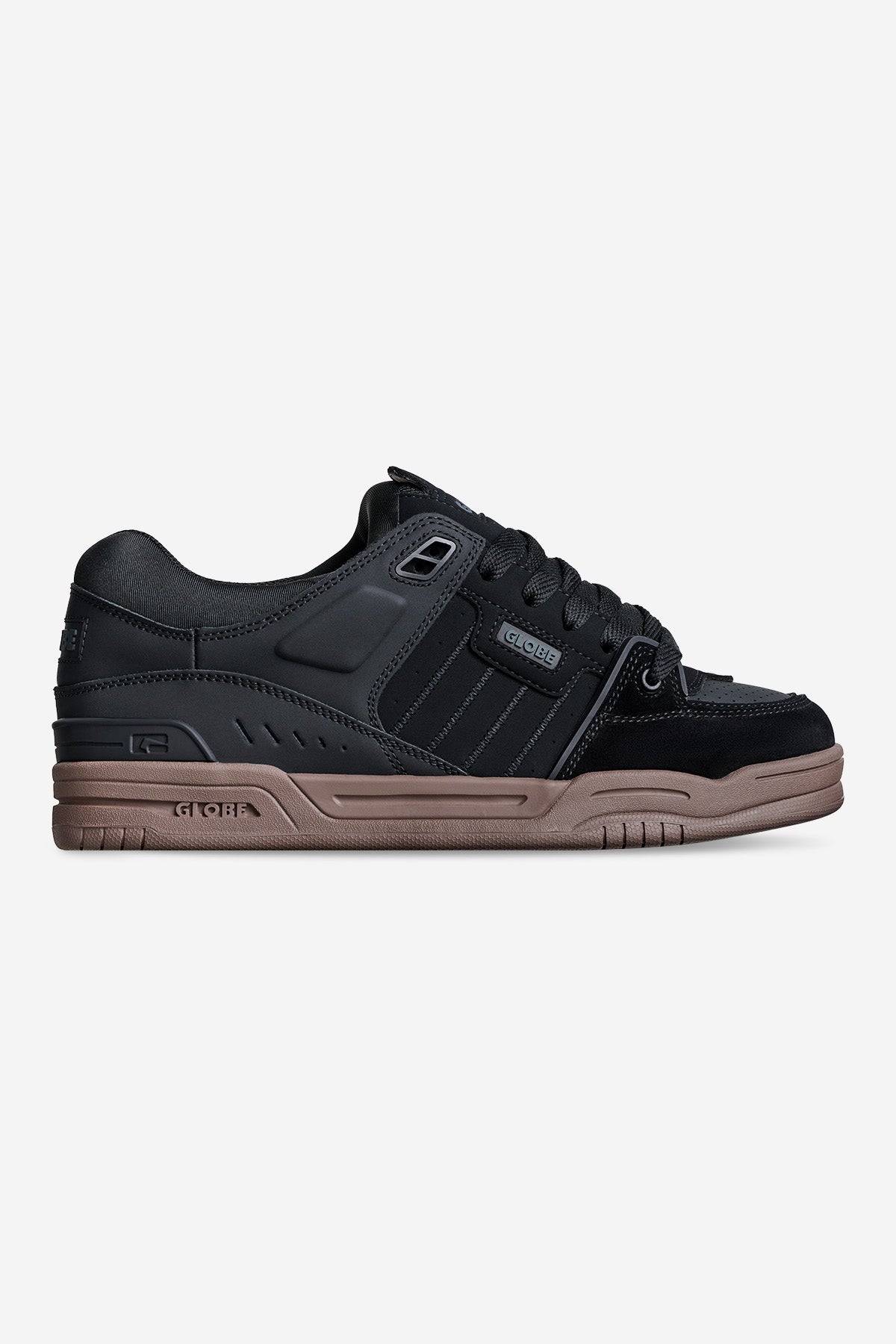 The Fusion - Black/Tobacco Gum is a black low-top sneaker featuring black laces, subtle stripe details, and a thick tobacco gum sole. Its sporty yet casual design makes it ideal for everyday wear.