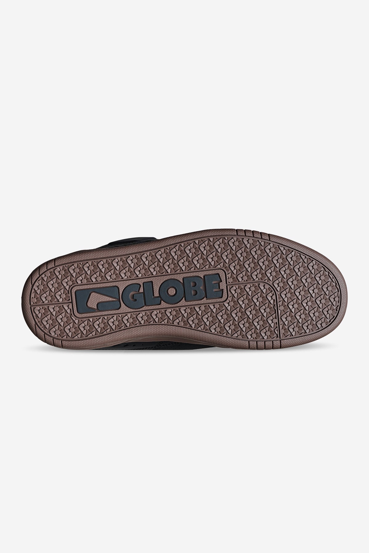 The image shows the brown rubber outsole of the Fusion - Black/Tobacco Gum shoe with GLOBE and its logo embossed in black at the center. The sole has a textured, patterned grip for traction.