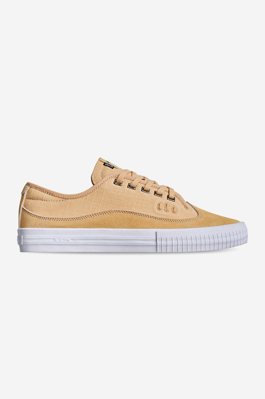 The Gillette - Khaki Linen is a tan low-top sneaker with a white rubber sole and white stitching, displayed in side profile against a plain white background.