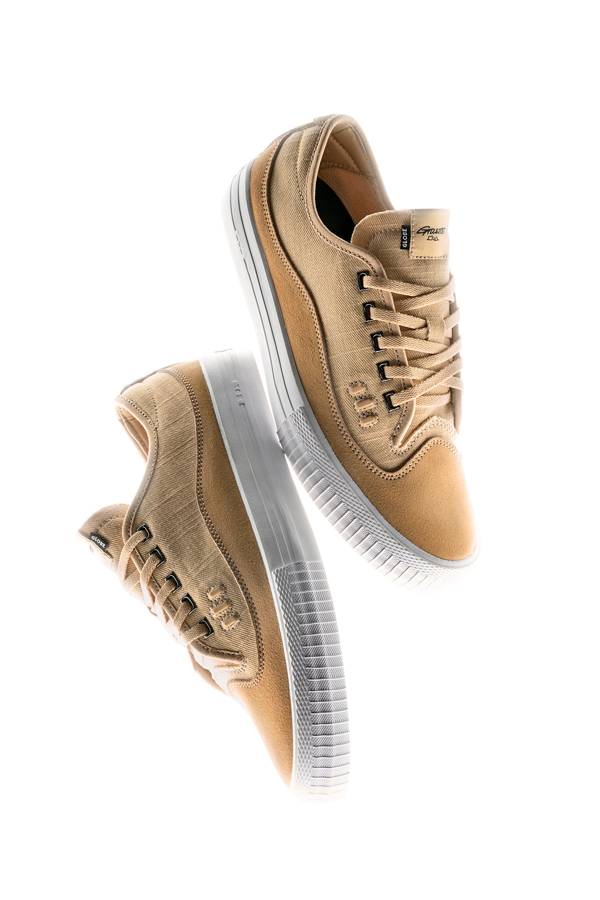 Two Gillette - Khaki Linen sneakers with white rubber soles are placed diagonally on a white background, one facing up and the other down, highlighting their khaki linen texture and laces.