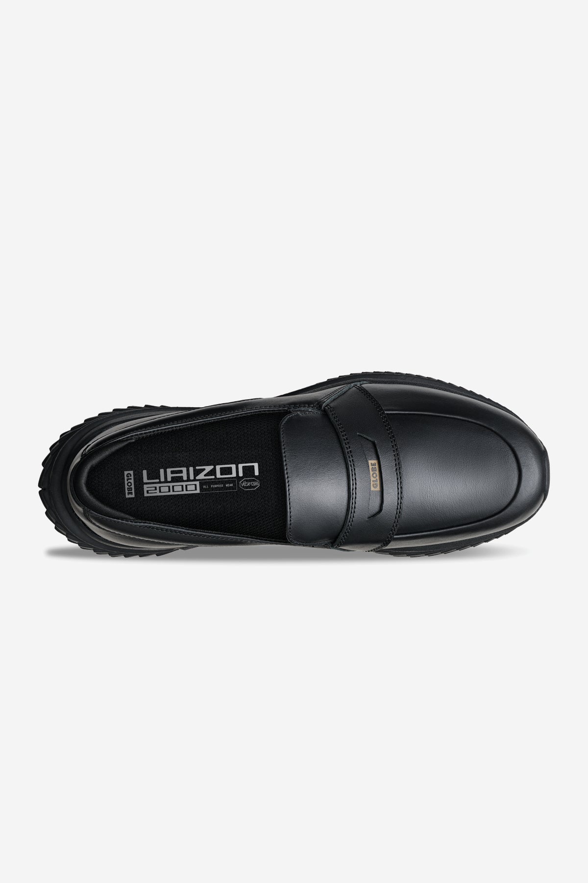 Top view of the Liaizon Vibram - Black loafer featuring a rounded toe, textured rubber sole, and branding on the insole and a small metal tag on the upper.