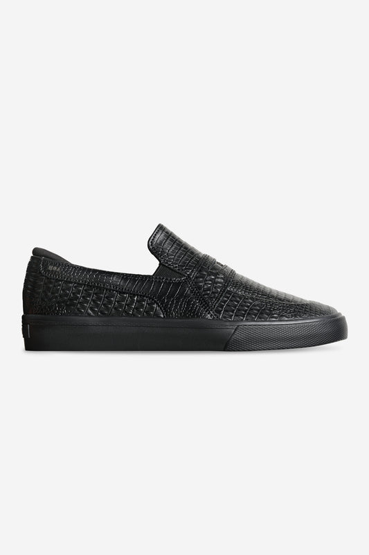 Black crocodile embossed slip-on loafer for skateboarding with a low rubber sole