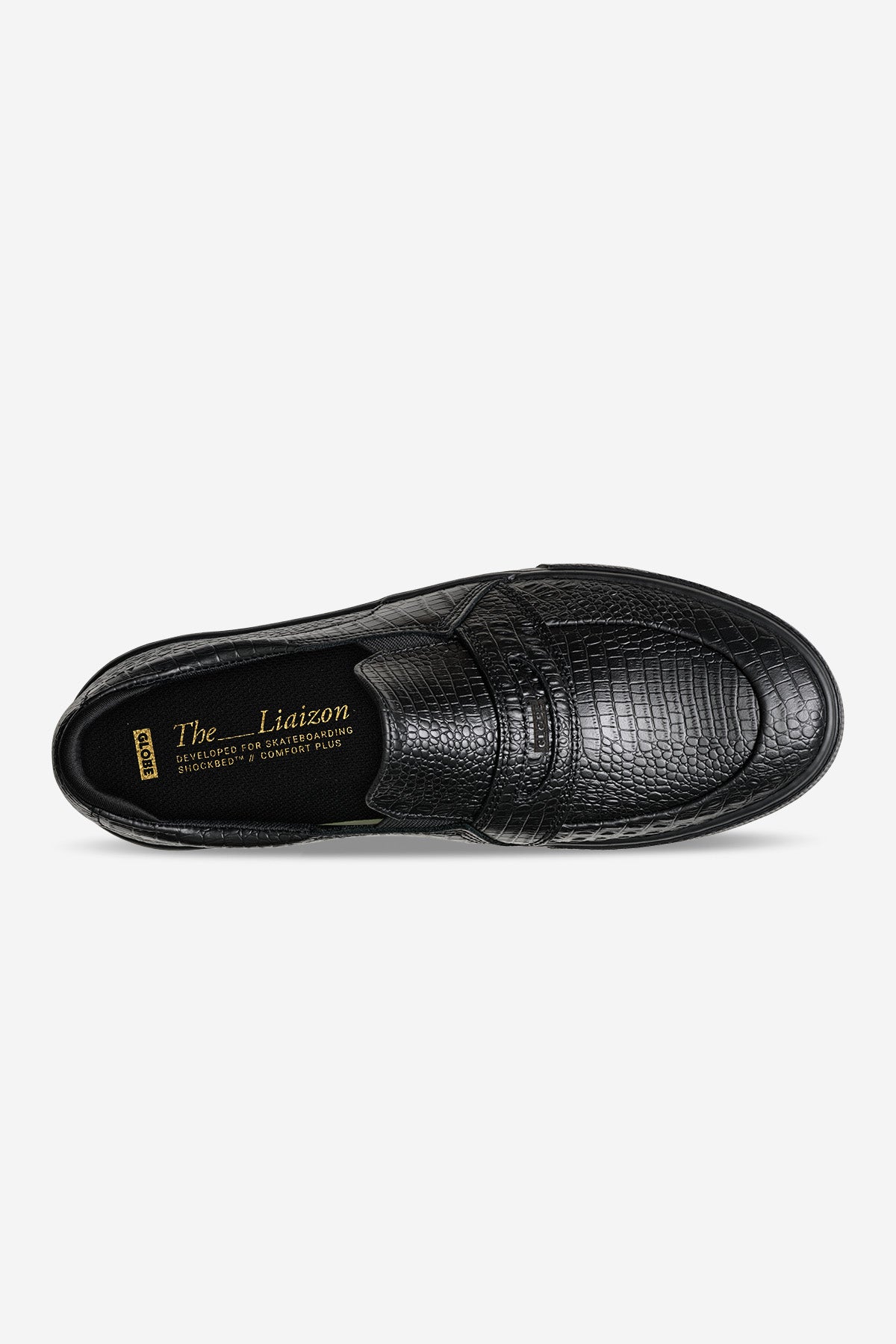 Top view of black crocodile embossed slip-on showing textured upper and strap detail