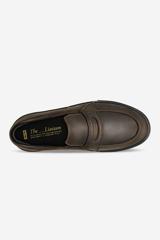 Top view of brown and black Liaizon skate loafer style slip-on with strap across the vamp and gold printed insole