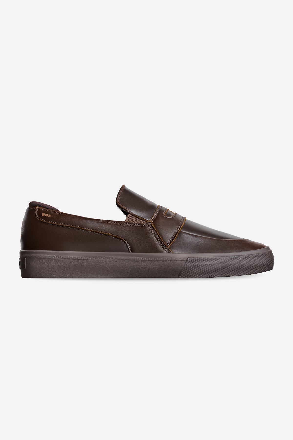 The Liaizon - Dark Brown is a low-profile, slip-on sneaker with a round toe and rubber sole, crafted from dark brown leather and displayed in side view against a plain white background.
