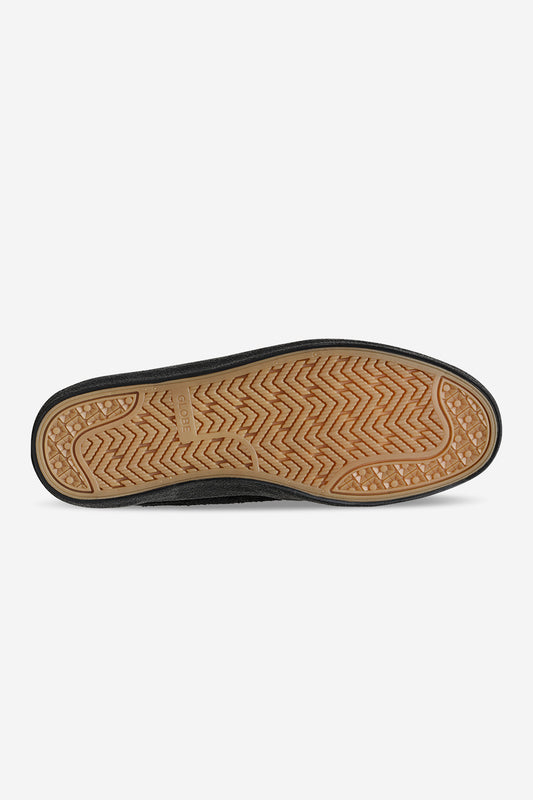 Bottom view of black Mahalo sneaker showing tan gum outsole with herringbone tread and Globe logo