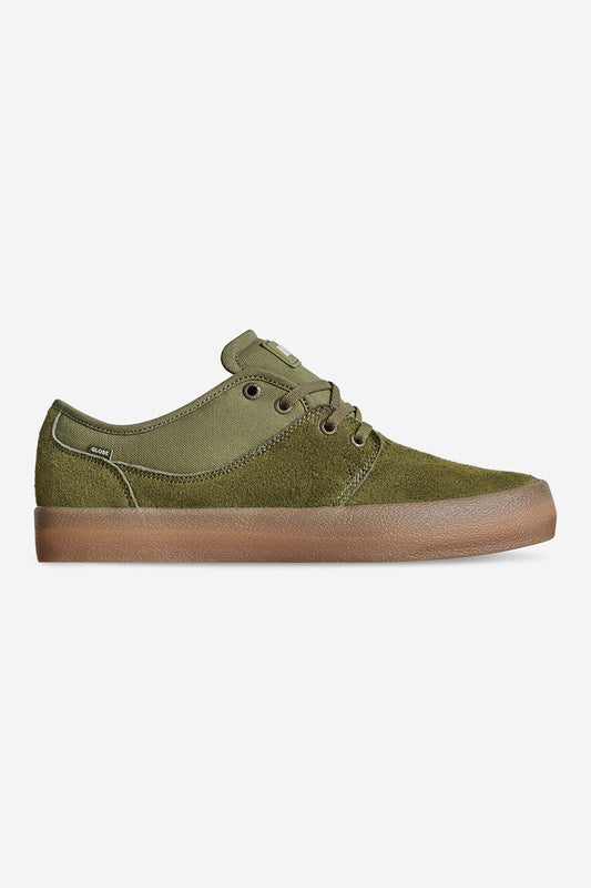 The Mahalo - Military Olive/Crepe is a green low-top sneaker featuring suede and canvas textures, a lace-up design, and a brown rubber sole, shown in side profile on a plain white background.
