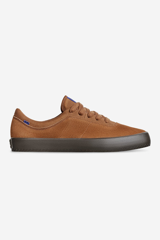 The Melbek - Caramel is a brown low-top sneaker with matching laces, a suede-like texture, and a dark rubber sole, displayed in side profile on a white background.