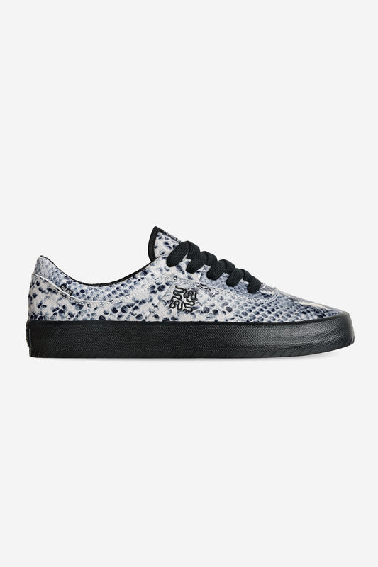 The Melbek - Wasted Talent Black/Snake is a low-top sneaker with a black sole and laces, a white and gray snakeskin upper, and a small black side logo.