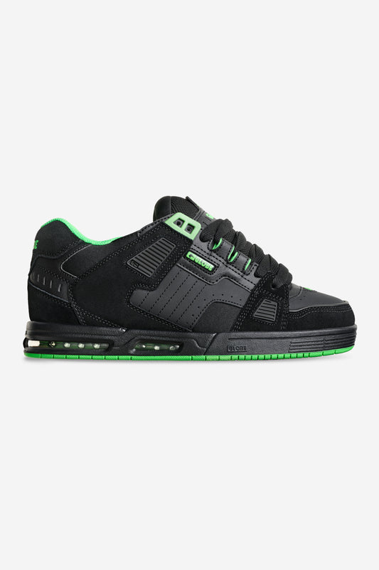Globe Sabre black and neon green skate shoe side view with padded collar and reinforced upper.
