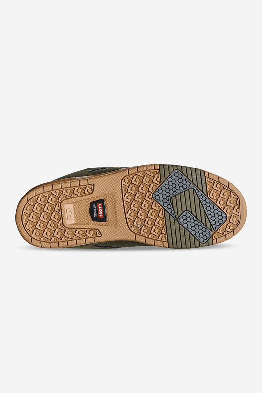 The image shows the treaded outsole of the Sabre - Moss/Gum shoe, with tan, brown, and gray geometric patterns and grooves. The Globe logo is near the heel, while textured designs highlight the toe and forefoot areas.