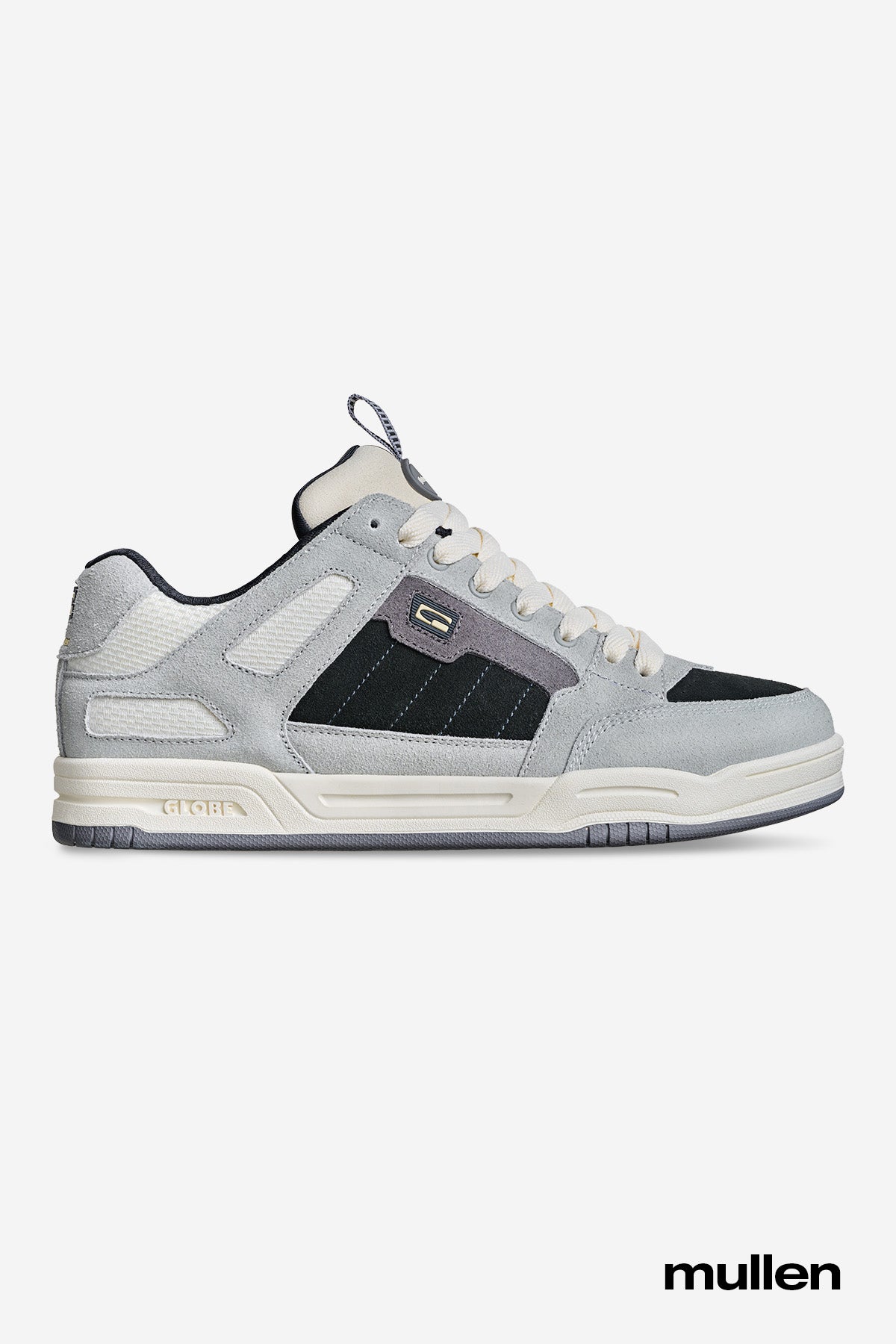 The Tilt Prime - Grey / Mullen skate shoe features light gray and black colors, white laces and accents, a thick sole, suede and mesh details. "Mullen" appears in black text to honor skate legend Rodney Mullen.