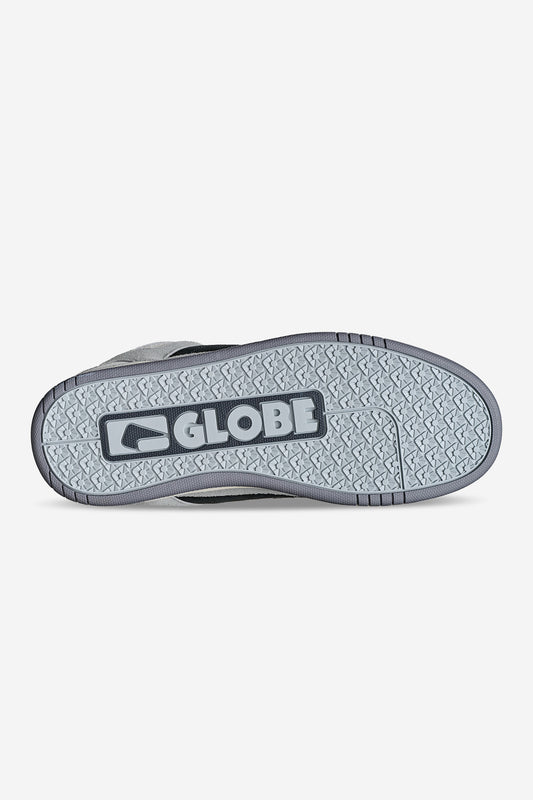 The image displays the sole of the Globe Tilt Prime - Grey / Mullen skate shoe, featuring "GLOBE" and the brand’s logo at the center. The gray, textured sole offers grip ideal for skaters like Rodney Mullen.