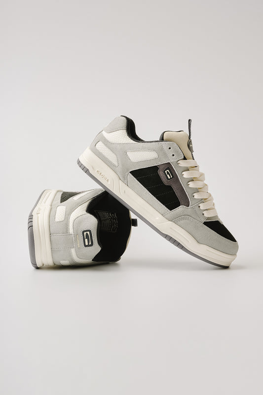 A pair of Globe Tilt Prime - Grey / Mullen low-top sneakers, one flat and one propped to display the sole and side details, shown against a plain white background.