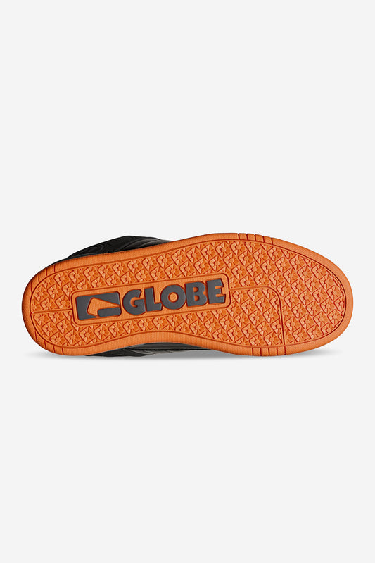 Outsole view of Globe Tilt black orange skate shoe with bright orange tread and Globe logo