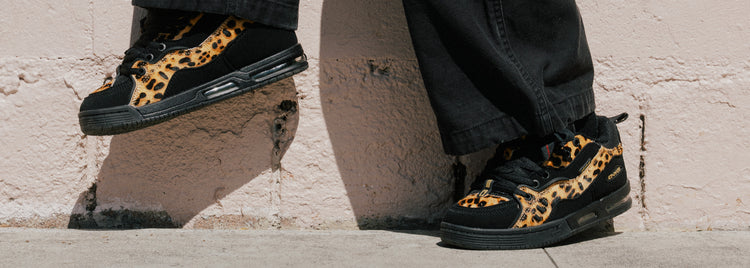 Lifestyle image of the Heritage Animal Pack shoes. 