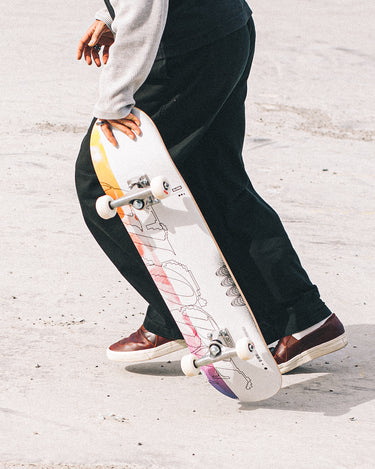 Action shot of skateboarder running to throw down. 