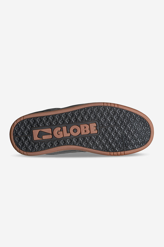 The image shows the sole of the Mojo 2.0 - Black/Gum shoe with a brown and black pattern. The GLOBE logo appears in the center, showcasing the Strobo cupsole design for added durability in this heritage classic style.