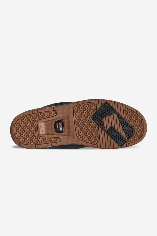 Bottom view of Sabre outsole showing brown gum tread and black traction pads
