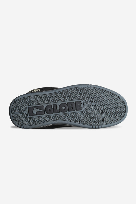 The image shows the sole of the Tilt - Black/Black TPR heritage skate shoe, featuring GLOBE and its logo embossed in the center. Its Strobo cup sole offers a textured, patterned grip for enhanced traction.