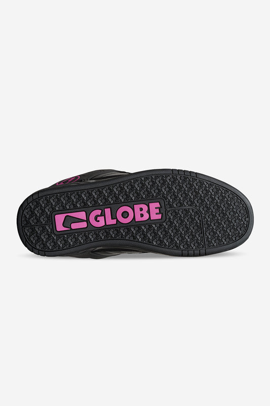 The image shows the black rubber S-Trac sole of the Tilt - Black/Black/Pink shoe, featuring a pink GLOBE logo and emblem at the center. The textured tread pattern includes small geometric shapes for enhanced grip.