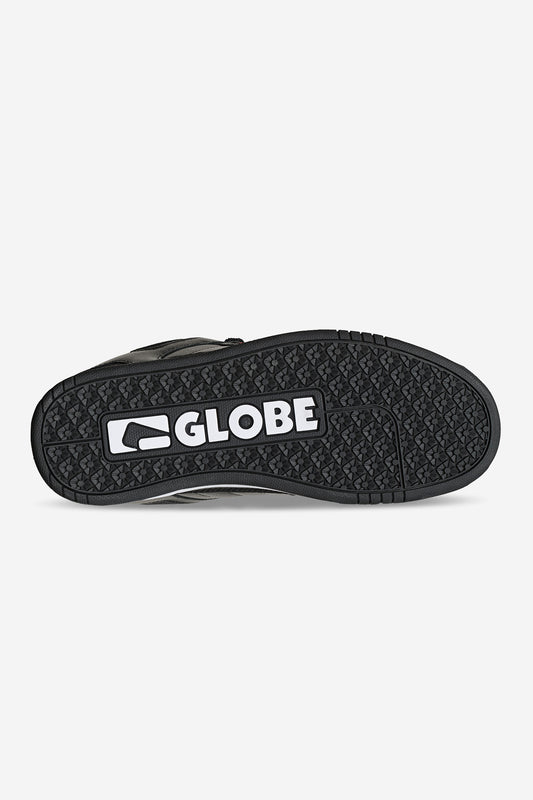 The image shows the black rubber sole of the Tilt Prime - Black / Mullen skate shoe, featuring a textured grip pattern and prominently displaying "GLOBE" and its logo in white, reflecting Rodney Mullen’s signature style.