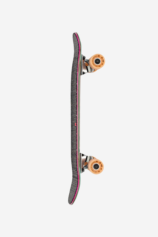The Kids Blaster Cruiserboard 8.25" - Pirate Life is shown from the side with black griptape, multicolored edges, and tan wheels, set against a plain white background.