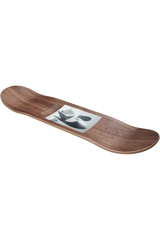 The Eames Silhouette Deck 8.0" - Plywood Sculpture is a wooden skateboard deck with a natural finish and central black-and-white abstract graphic, featuring upturned nose and tail, without wheels or trucks attached.