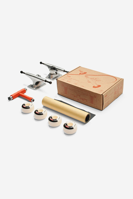 The Everything But The Deck Kit Accessories Hg 5.0" - Raw Finish includes Slant trucks, four wheels, a T-shaped tool, grip tape, and a box, all neatly displayed on a white background.