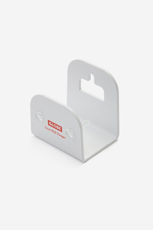 A white "Skateboard Deck Wall Hanger Accessories Hg 1sz" features rounded edges, red and black labeling, two mounting screws, and a keyhole slot—perfect for displaying your skateboard deck on the wall.