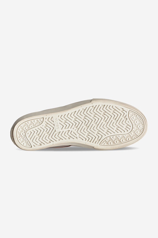 The image shows the sole of the Liaizon - Oxblood/Maalouf sneaker in beige, featuring a textured herringbone tread and circular grips along the edges, reminiscent of classic skate shoes. The brand name Rothys is embossed at the center.