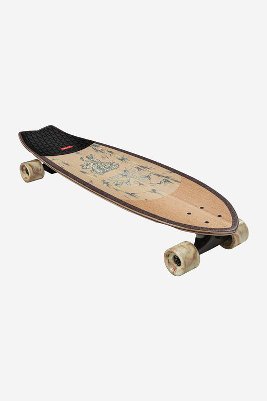 The Chromantic Cruiserboard 33" - White Oak/Jaguar is a surf-inspired skateboard featuring natural wood tones, subtle jaguar artwork, transparent wheels, and a textured black rear grip pad.