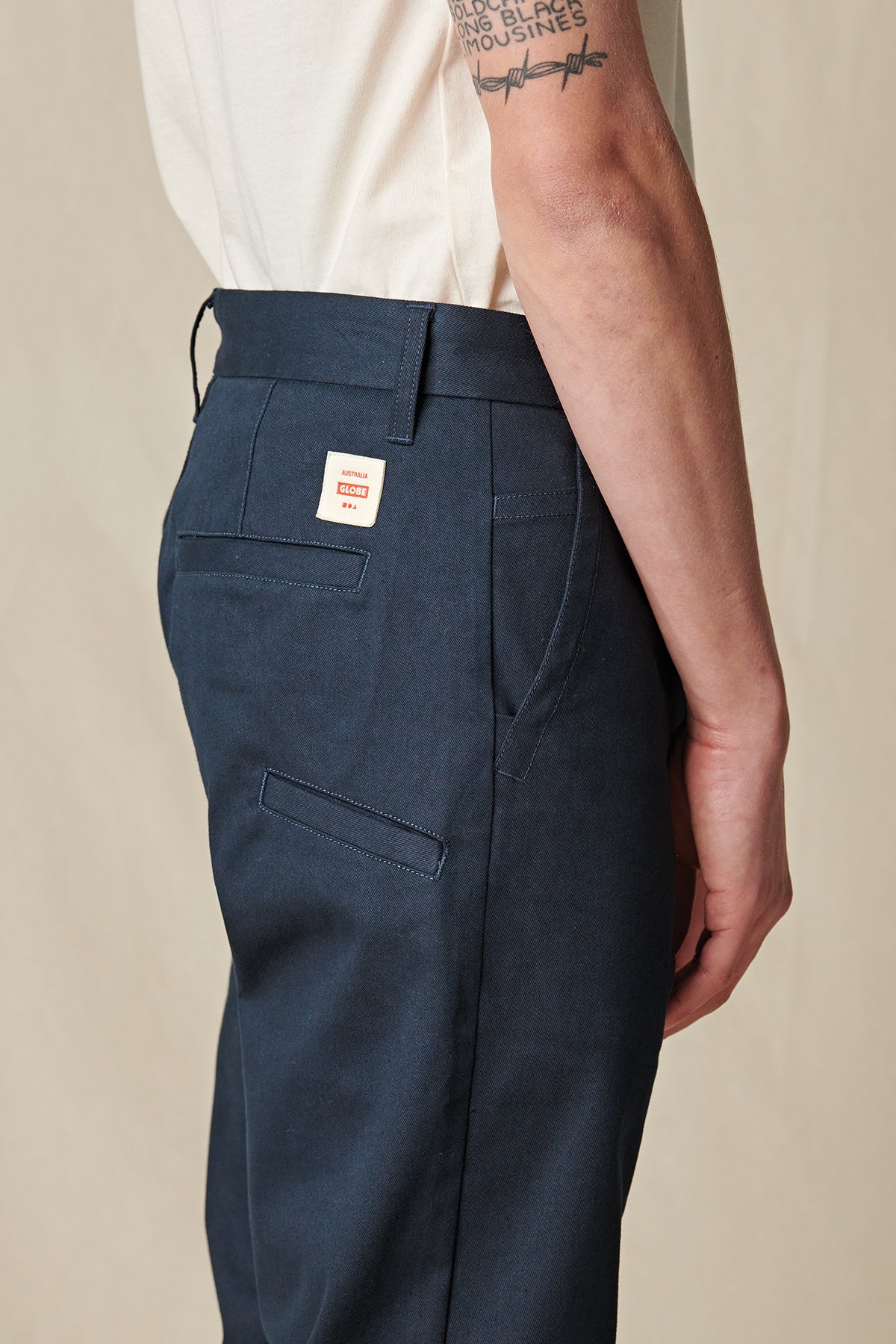 back pocket detail of Navy Globe Pants. 