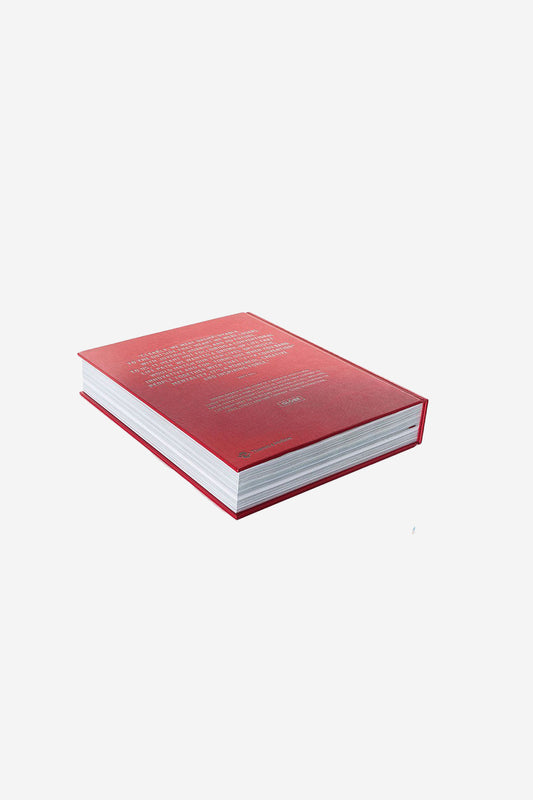The closed Anniversary Book UNEMPLOYABLE - Version 2 RED, with a red hardcover and white pages, lies flat on a white background. The angle displays its back cover and spine in a style similar to Globe International designs.